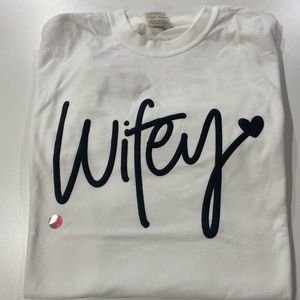 BRAND NEW, never worn. Black Wifey Puff Print Design, White Shirt, Size M & L